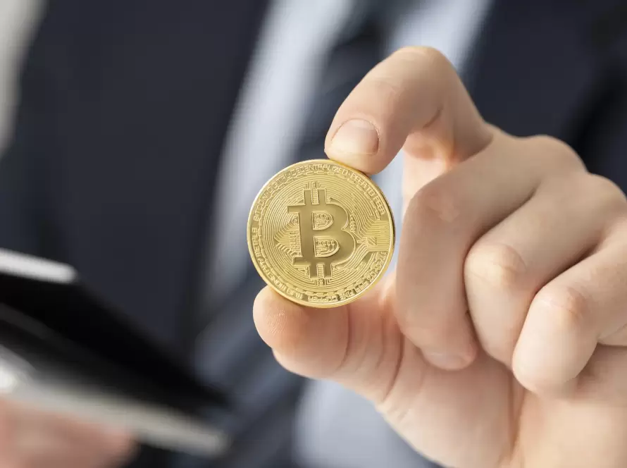 Businessman holding a Bitcoin coin, representing the growing need for crypto tax guidance and financial advice