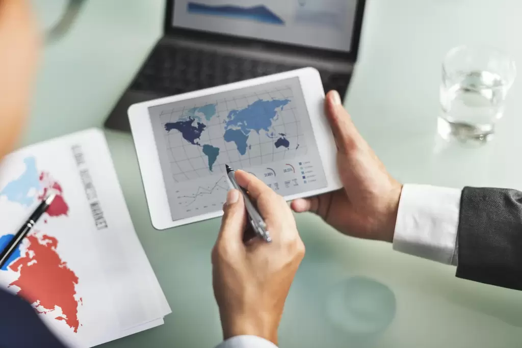 Real Estate Lawyers 7 Professionals analyzing international Taxation in Holding Companies strategies on a global map.