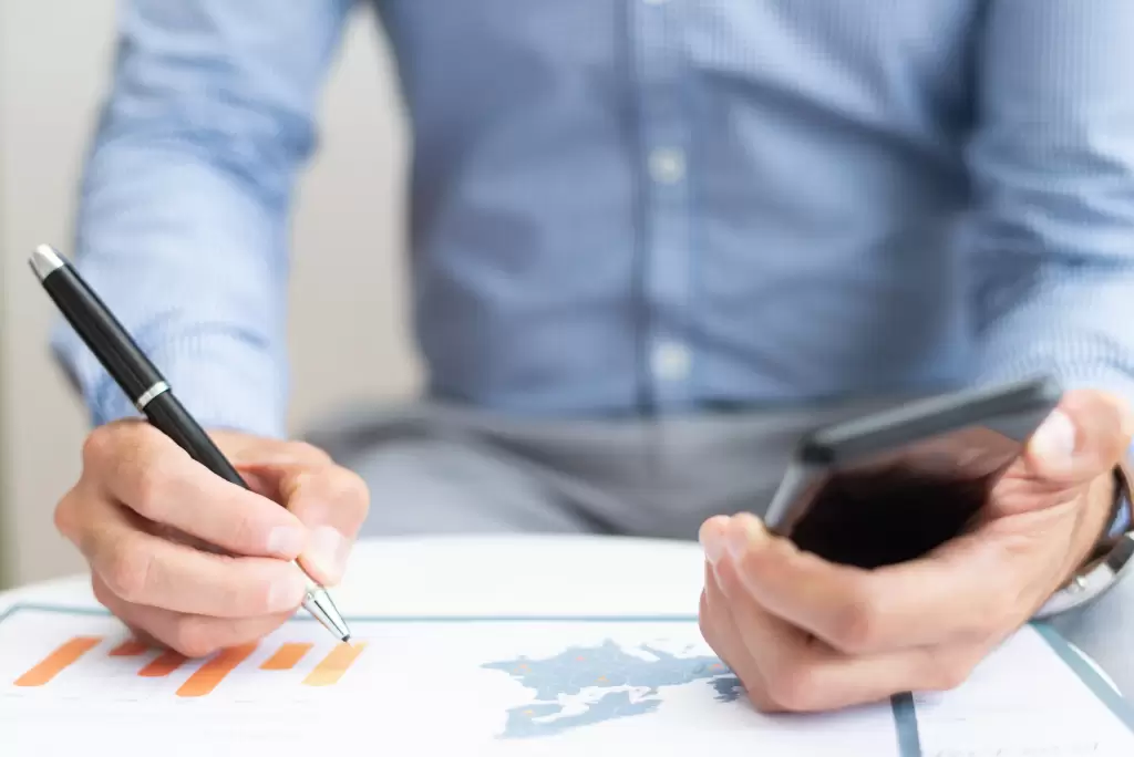 Benavides Asociados 7 International taxation analysis and cross-border fiscal review: an advisor examining investment charts and tax compliance data.