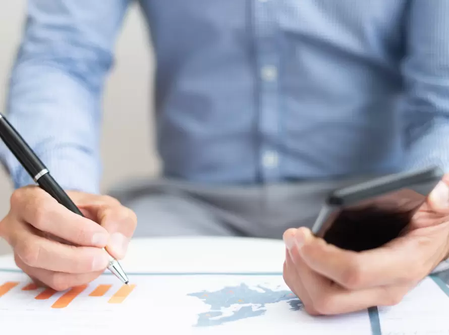 International taxation analysis and cross-border fiscal review: an advisor examining investment charts and tax compliance data.